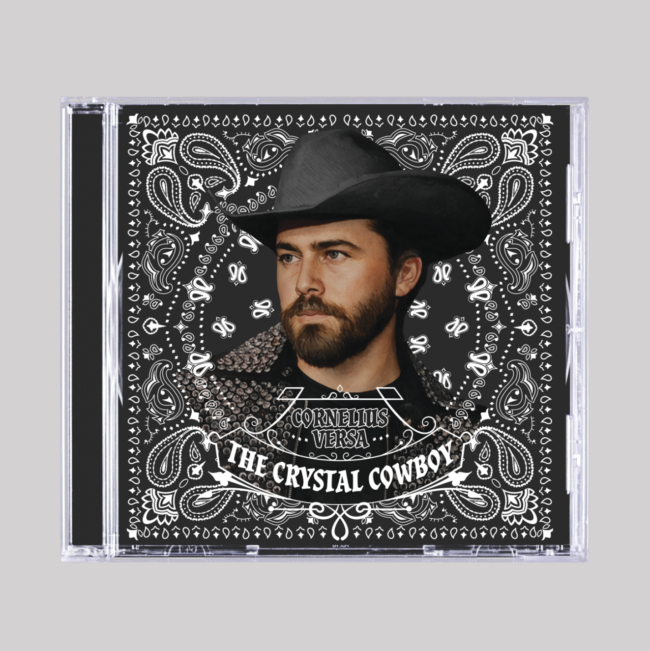 CD cover with a person wearing a cowboy hat and bandana, featuring decorative patterns and text.